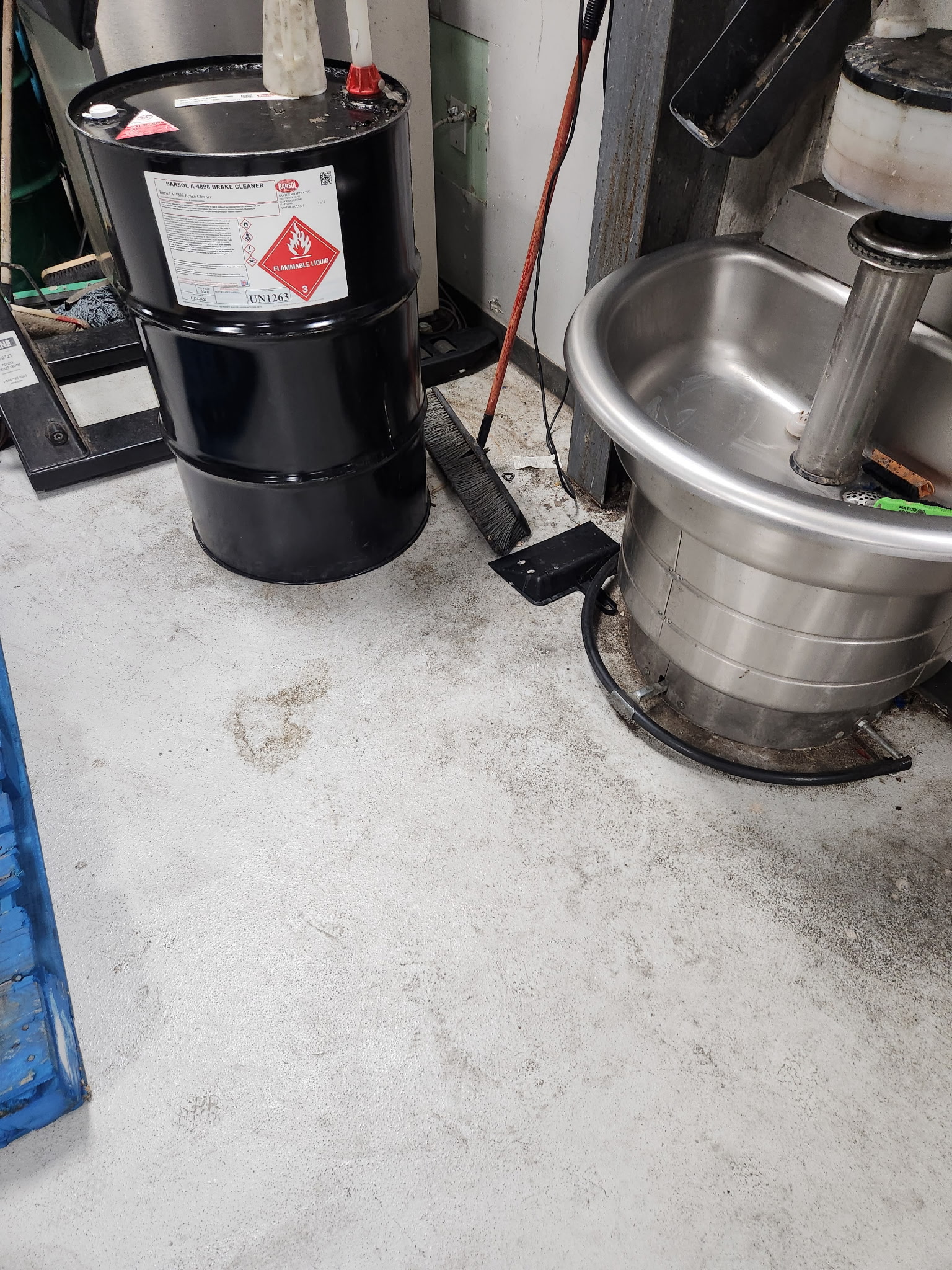 Dirty auto shop floor before deep clean