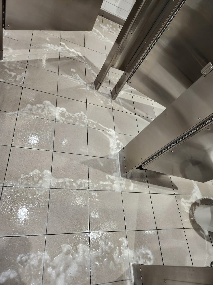 Suds washing bathroom floor