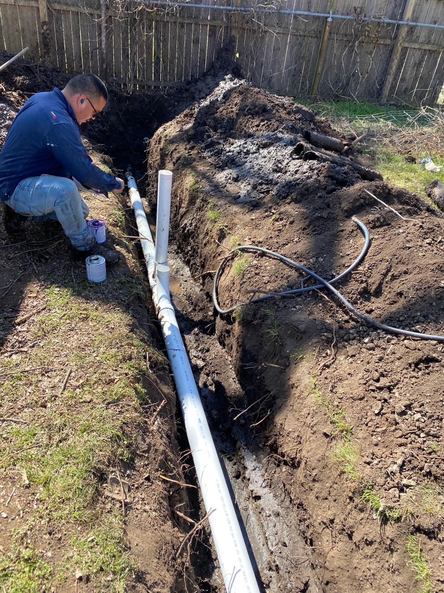 Before: exposed ground and utilities during sewer line work