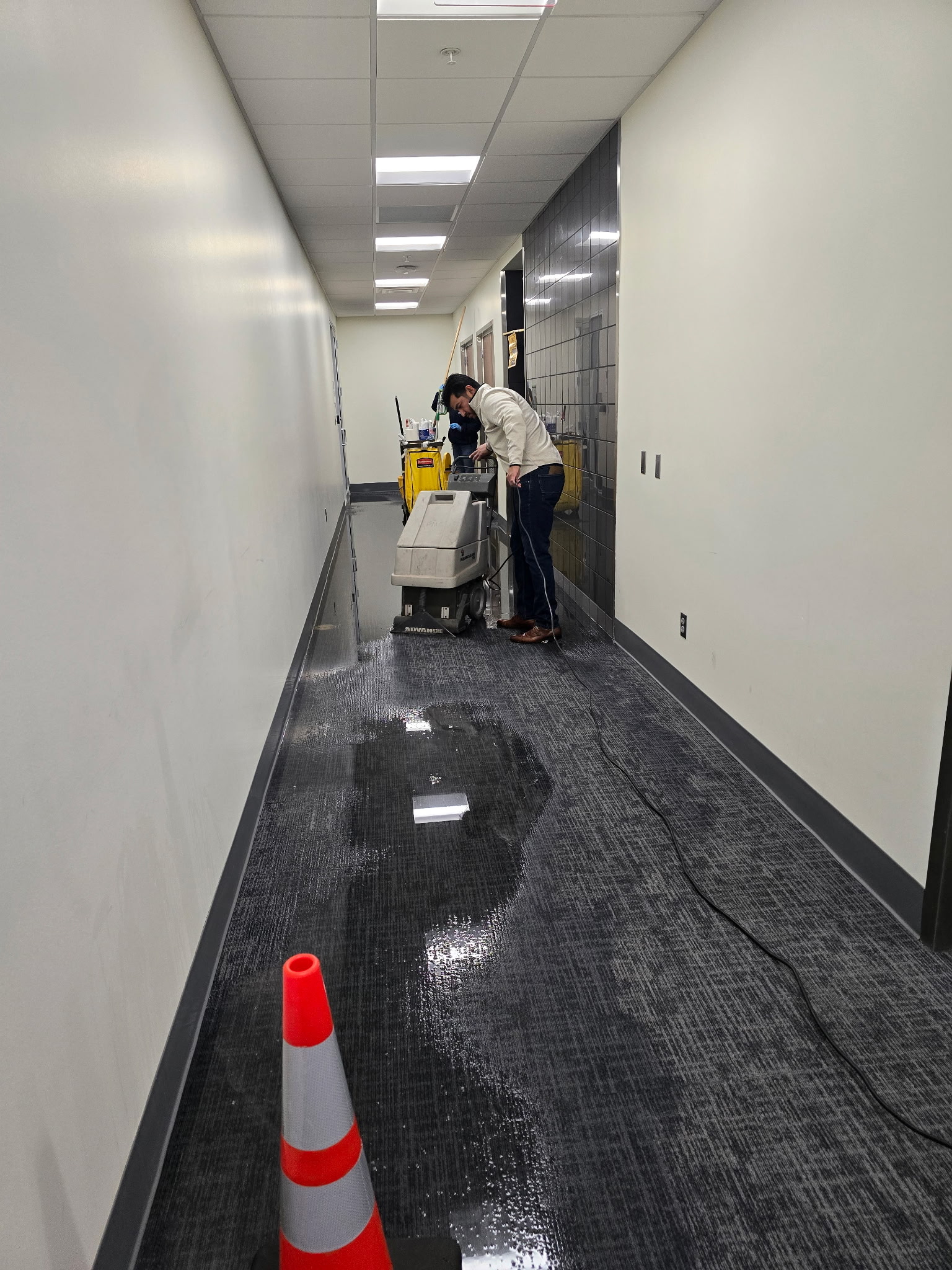 Team addressing water emergency in hallway