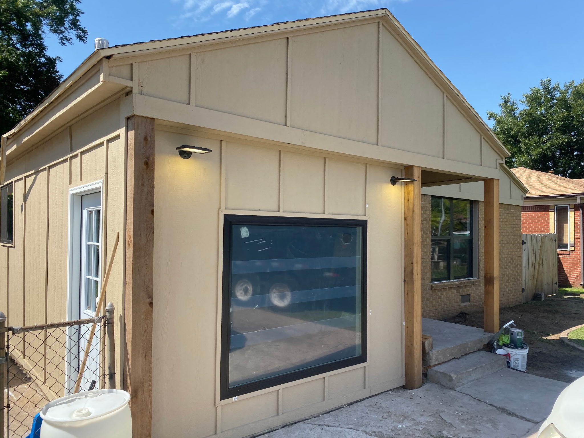 Home upgrades after trim, windows, siding and lights installed