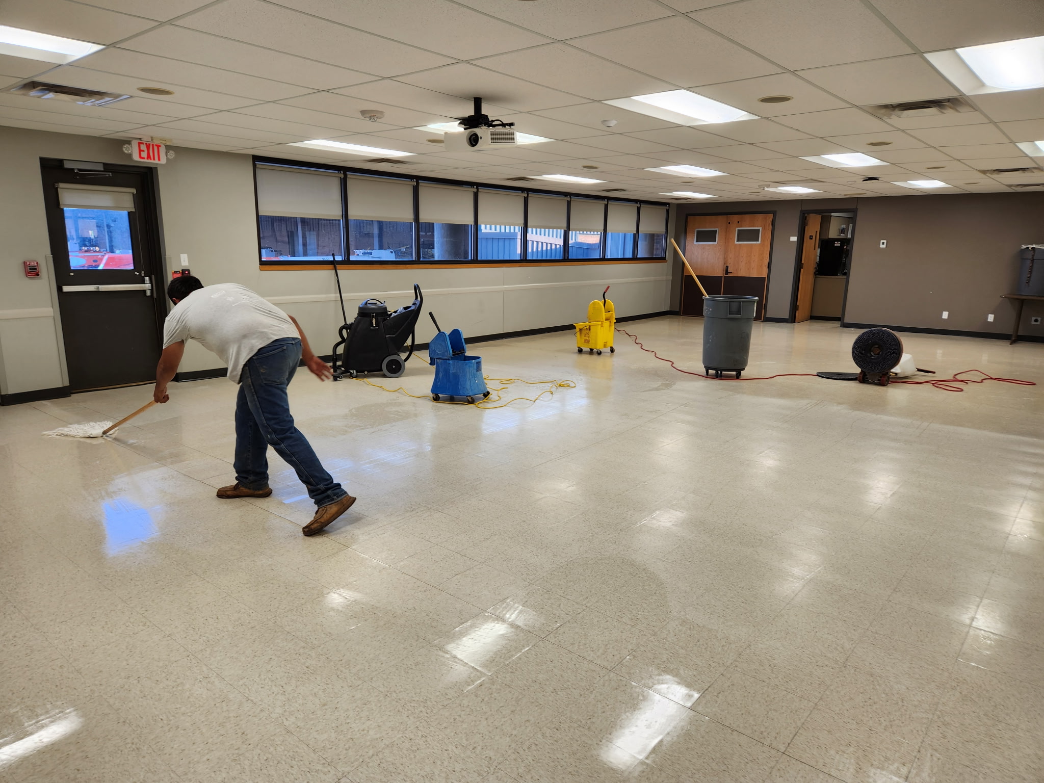 Worker cleaning hallway